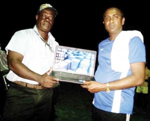 Mr. Bharat Narine (right) hands over the Laptop Computer to Grove Hi Tech President, Kevin Anthony. 