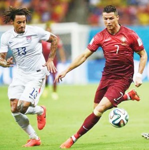 Portugal’s Cristiano Ronaldo, right, runs with the ball as United States’ Jermaine Jones guards during the group G World Cup soccer match.  (AP Photo/Paulo Duarte)