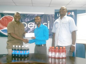 Mr. Ninvalle gratefully collects the sponsorship package from Mr. Wills in the presence of Mr. Poole