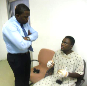 Alleged torture victim Junior Thornton explains to attorney at law Dexter Todd how he got his injuries.