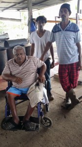 Mr. Doodnauth (in wheelchair) and the two employees that the bandits attacked.