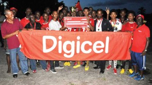 Digicel Representative Seon Jackman hands over the winning cheque and trophy to BV Secondary School Captain in the presence of teammates and officials on Saturday, at the St. Cuthbert Mission Community Centre ground.