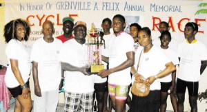 Mario King receiving the Lien trophy from Russell Felix as other prize winners and members of the Felix family look on.