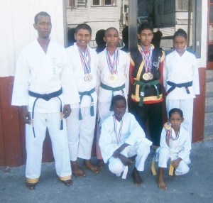 Master Lloyd Ramnarine (left) and his successful Karate  team from the Westminster Karate Club with their medals.