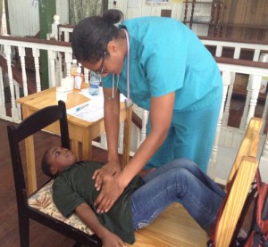 Dr. Kamica Lewis examines a child complaining of stomach aches.