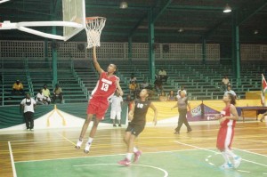PROLIFIC! National junior centre, Ginelle Ifill, fundamentally finishes a right-handed lay-up at the Cliff Anderson Sports Hall Saturday night in an 18-point performance that also included 20 rebounds to help the defending champs beat Suriname.