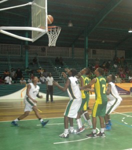 COUNT IT IN! Terron Welch (left) puts this one high off the glass after beating all and sundry with a baseline move last night at the Cliff Anderson Sports Hall to help Guyana beat the French Guiana team.