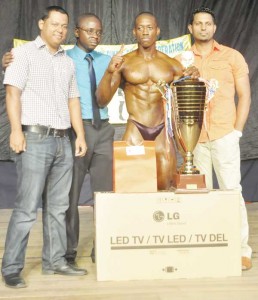  Mr. Guyana 2014 Kerwyn Clarke surrounded by GABBFF President Kevon Bess (2nd left) along with Fitness Express rep at left and Digital Technology’s rep at right.