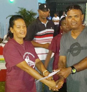 NY Blasters Shameer Sadloo makes a donation to Elizabeth George after the match.