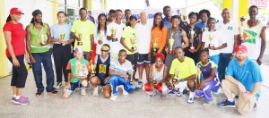 Neal and Massy Group CEO Deo Persaud strike a pose with the winners of the fourth Annual NM 10K athletic road race. 