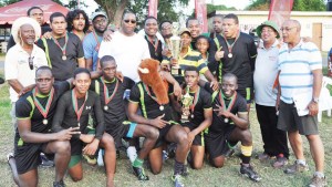 Banks DIH Outdoor Events Manager Mortimer Stewart (centre) poses with the victorious University of Guyana team following the presentation ceremony yesterday.
