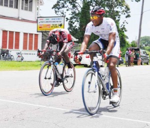 Michael Anthony (right) crosses the finish line on Homestretch Avenue ahead of Hamza Eastman yesterday. (Franklin Wilson photo)  