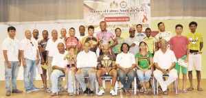 Minister Frank Anthony (seated 2nd left) and Director of Sport Neil Kumar (right) pose with the recipients of prizes.