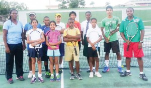 Players of the national squad capture a Kodak moment with coaches Shelly Daly-Ramdyhan and Nicholas Glasgow.