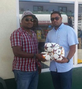 Chief Operations Manager of Hopkinson Mining Michael Martindale (left) handing over his company’s donation of balls and other gear to Slingerz FC President Javed Ali. 