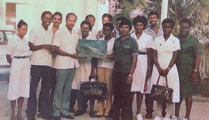 The OB/GYN being presented with a painting of the Canje River Bridge by nurses and other staff members at the N/A Hospital upon his retirement 