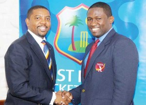 West Indies Players Association (WIPA) president Wavell Hinds (right) and West Indies Cricket Board (WICB) president Dave Cameron shake hands on the players’ CBA/MOU in September. (Courtesy WIPA)