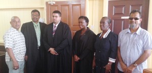 Newly-admitted Attorney Shaunella Glen, is flanked by Justice Nareshwar Harnanan, Attorney at law Khemraj Ramjattan, Businessmen Glenn Lall and Nazar ‘Shell’ Mohamed and her mother Desiree Glen yesterday at her admission ceremony 