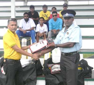Michael Newland, Station Sergeant, First Division, Central Berbice receives the kit from GCB Secretary, Anand Sanasie.