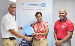 Copa Airlines Country Sales Manager Nadine Oudkerk (centre) hands over the signed Letter of Commitment to David Gomes, Flex Night Inc. Director of External Affairs in the presence of Managing Director, Donald Sinclair.  