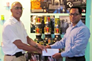 David Gomes. Flex Night Director of External Resources (left) receives the commitment of sponsorship from Mr. Reginald Persaud, Managing Director of IPA.