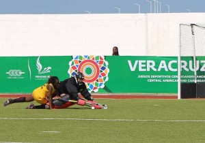 Guyanese goalkeeper Alysa Xavier blocks the penalty attempt by Jamaican Demi Nicholson.