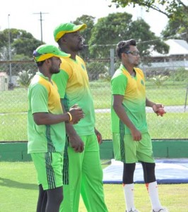 Head Coach Esuan Crandon is flanked by his spin twins (Bishoo right & Permaul) during yesterday’s practice session at the stadium.