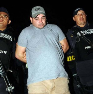 National Police agents escort Plutarco Antonio Ruiz, the boyfriend of Miss Honduras Maria Jose Alvarado’s sister in Santa Barbara