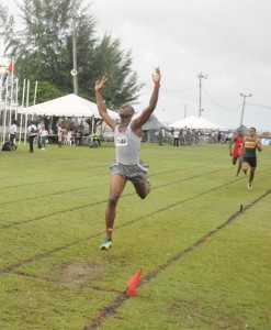 East Bank Demerara’s, Kwesi Blair thanks the heavens for victory as he approaches the finish line in the U-18 Boys’ 800m yesterday at the Base Camp Ayanganna Ground.