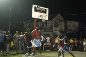 Flashback! Onlookers pay attention to the keen battle at the Independence Boulevard Basketball Court two years ago. Mackeson 3x3 Basketball Championships returns tonight in Albouystown.