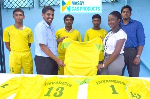 Massy Gas Products presentation: Invaders Captain Vaickesh Dhaniram receives the uniforms from Massy Gas Products Customer Services Officer Elicia Chapman while some members of the team look on.