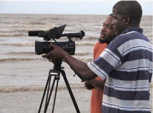 With cinematographer Noel Harlequin on the set of ‘Beached’