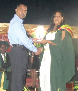 Ms. Mootoo receiving her prize from a representative of Republic Bank