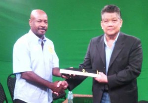 The satisfied look says it all as Mr. Messiah (left) collects the coveted accolade from Master Woon-a-Tai.