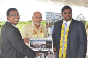  The Manager for the Sun and Sand Hotel, Bhushan Chandna (left) presenting the plan for the hotel to President Donald Ramotar and Minister of Tourism, Irfaan Ali.