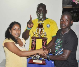 Kavita Latif (left) receives the winning trophy from Charwayne Mc Pherson of Boodhan Super Star on behalf of skipper Richard Latif, while Clyde Hoyte shares the moment. 
