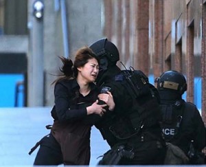 A young female employee came running out of the Lindt cafe shortly before 5pm and was sheltered by waiting police. (AP)