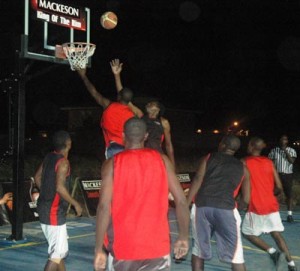 Melanie’s TRS Raptors, Ashton Adams (airborne, right) releases a high right-handed floater that evades Plaisance Guardians’ Ron Campbell at rim Thursday night when the Mackeson ‘King of the Rim’ 3x3 basketball continued in Plaisance.