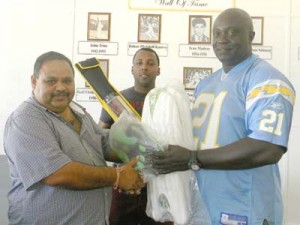GCB President, Drubahadur (left), handing over the gear kit to Linden Murray, CEO at Skeldon Estate, in the presence of BCB Head Coach Julian Moore. 