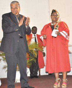 Valedictorian Sharon Scott is congratulated by Major General (retd) Joe Singh after receiving her award