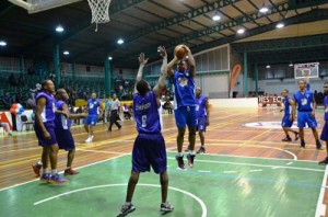 West Indies and Guyana cricketer, Christopher Barnwell, Team Bond’s leading scorer, takes a jumper in the paint Saturday night at the Cliff Anderson Sports Hall in the Respect the Game Charity Basketball Event.