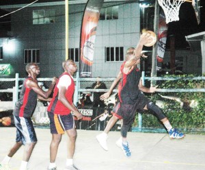 Colts ‘B’ Shooting guard, Shelroy Thomas releases a fade-away jumper in the face of Slash’s, Jason Squires, to lead his team to an upset victory, and a place in the Super Eight. 