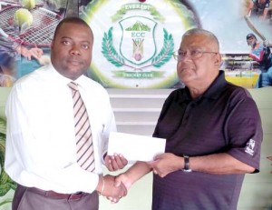President of the Everest Cricket Club, Stephen Lewis (left) hands over the cheque to Director of the Home, Surujnauth Surujpaul.