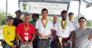 Overall winner Ryan Mc Kinnon (2nd right) flanked by other prize winners, Ray Beharry (2nd left) and Pravesh Harry (centre) poses with other competitors. GSSF President Ms. Vidushi Persaud is at left. 
