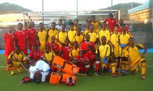 Guyana junior men’s national hockey team members (yellow) pose with Paragon junior squad shortly after the game.
