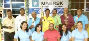 Saturday’s winners along with President Mohamad (seated) flanked by staff of Muneshwar’s Maersk subsidiary. Standing, from left to right Avinash Persaud, Jeetendra Danpat, Ramesh Anirude, Sam Harry, Ravi Persaud, Pur Persaud and Kalyan Tiwari.