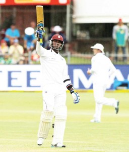 Marlon Samuels raises his bat after scoring a fifty. (AFP)