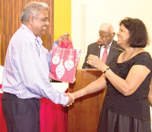 Nizam Ali received his loyalty award from Mrs Ameena Gafoor for being with Gafsons for 41-years  