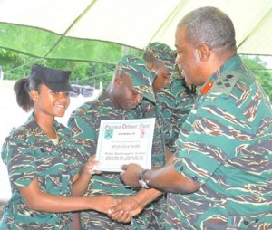 After receiving her paratrooping badge LCpl Lyte collects her certificate from the Chief of Staff. 