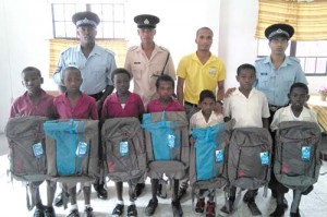 Some of the students that received gifts from the police along with several police officers.